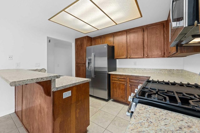 kitchen featuring light tile patterned floors, a kitchen breakfast bar, kitchen peninsula, and appliances with stainless steel finishes