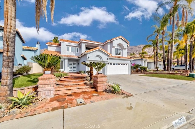 mediterranean / spanish home with a garage