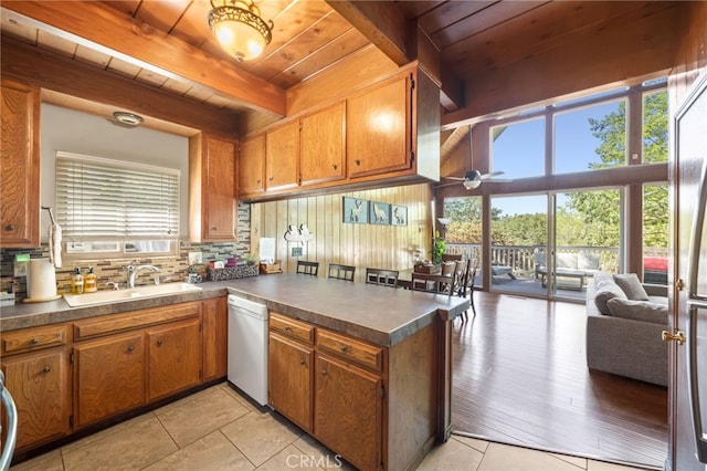 kitchen with tasteful backsplash, sink, a wealth of natural light, and white dishwasher