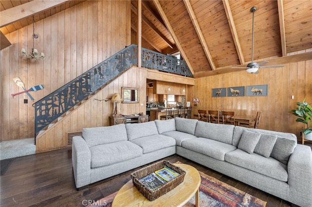 living room with high vaulted ceiling, wood walls, dark wood-type flooring, wooden ceiling, and beam ceiling