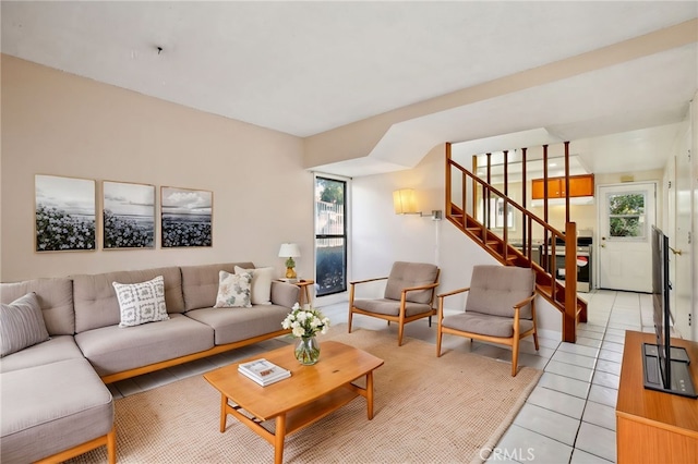 living room with stairway and light tile patterned flooring