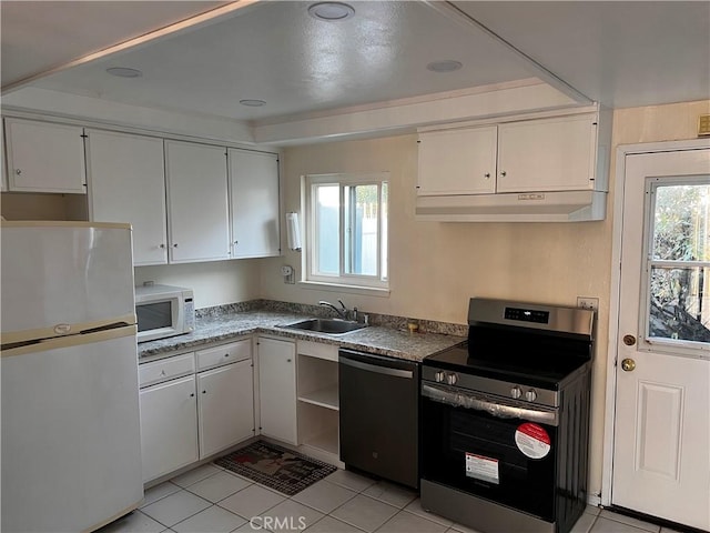 kitchen featuring a sink, under cabinet range hood, white appliances, white cabinets, and light tile patterned floors