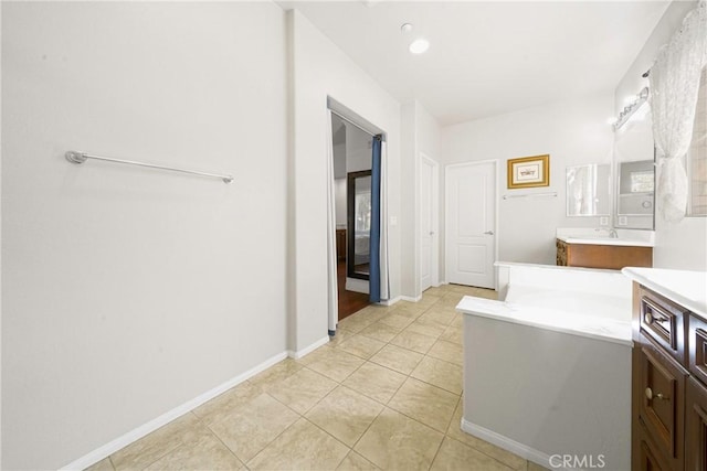 bathroom featuring tile patterned flooring and vanity