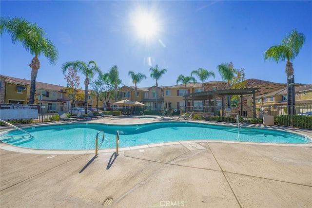 view of swimming pool with a patio and a pergola