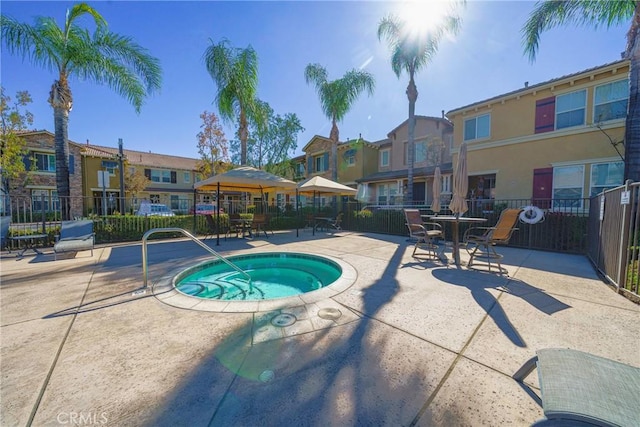 view of pool featuring a community hot tub and a patio area