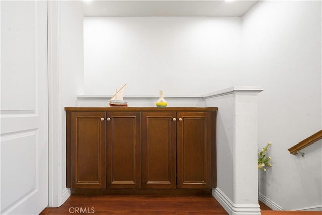 bar with dark hardwood / wood-style flooring