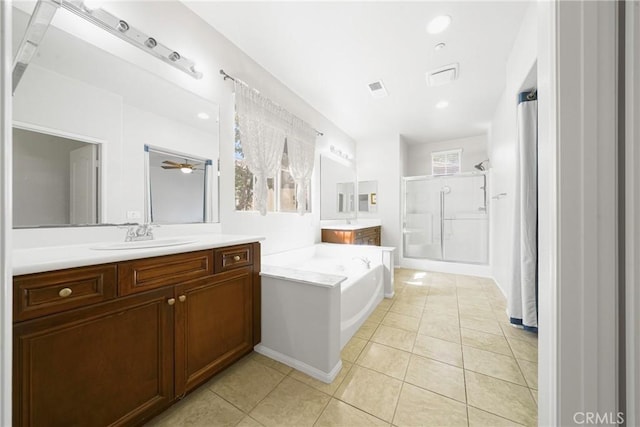 bathroom with vanity, tile patterned floors, and plus walk in shower