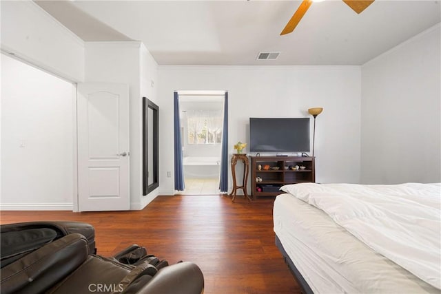 bedroom with crown molding, dark wood-type flooring, connected bathroom, and ceiling fan