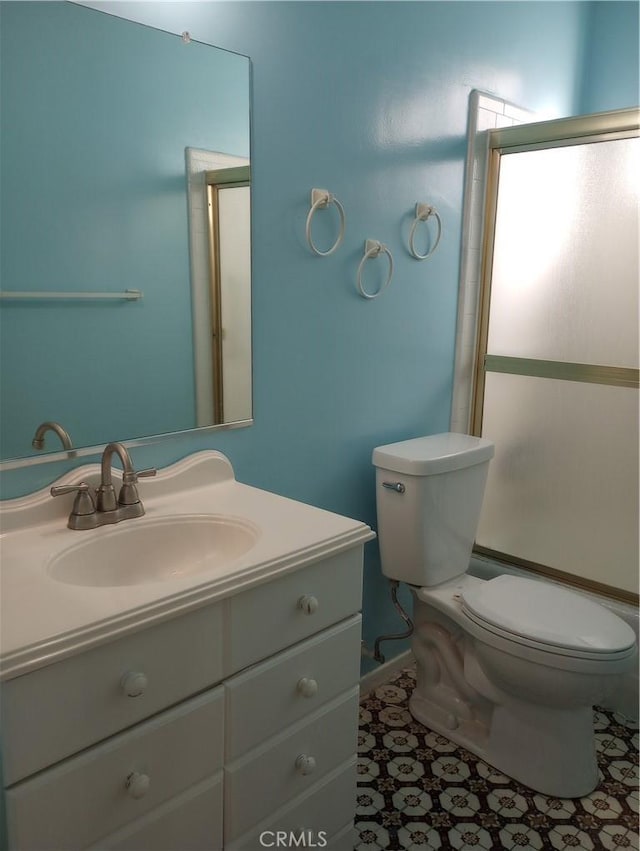 bathroom with vanity, an enclosed shower, tile patterned floors, and toilet