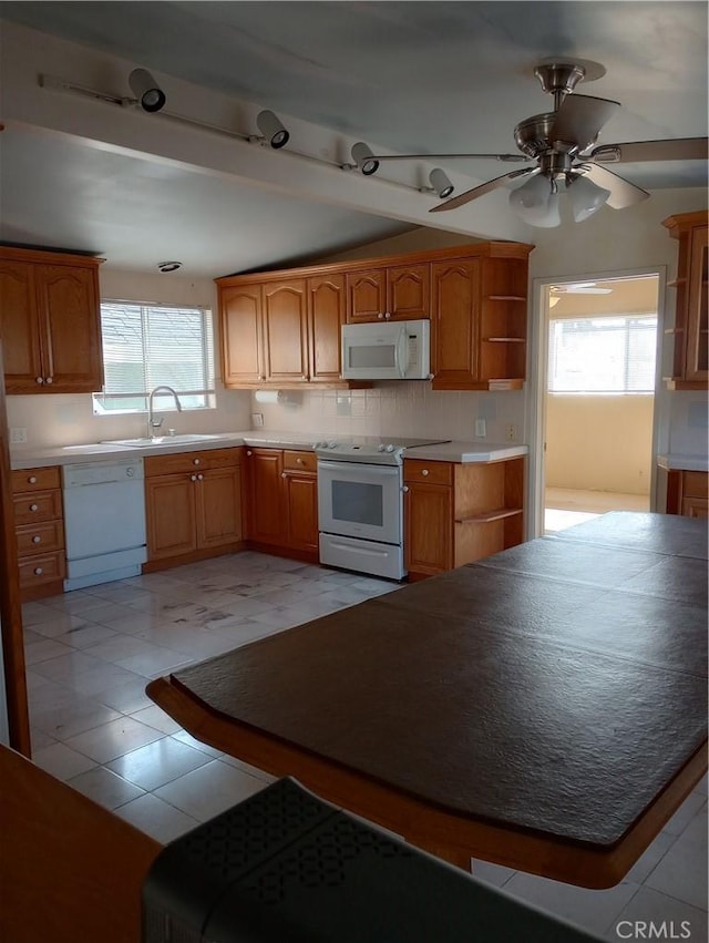 kitchen featuring tasteful backsplash, ceiling fan, sink, and white appliances