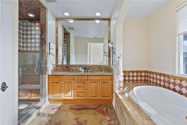 bathroom featuring vanity and shower with separate bathtub