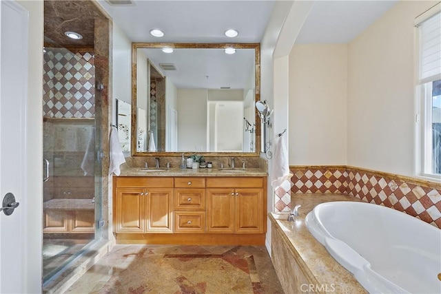 bathroom featuring a garden tub, a sink, visible vents, double vanity, and a stall shower