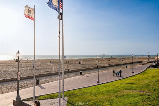 surrounding community with a water view, a yard, and a rural view