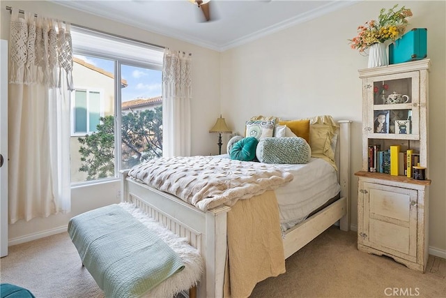 bedroom featuring baseboards, ornamental molding, and light colored carpet