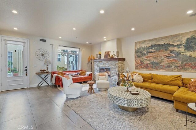 living room with a stone fireplace