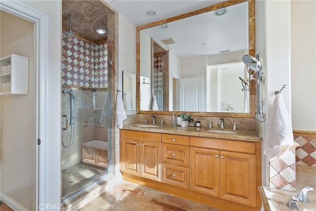 full bath with double vanity, a sink, visible vents, and a shower stall