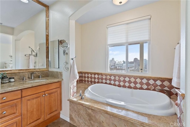 full bathroom with a view of city, vanity, and a bath