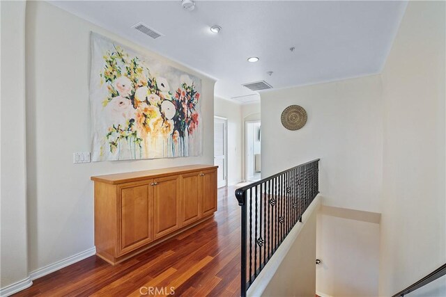 hallway with dark hardwood / wood-style floors