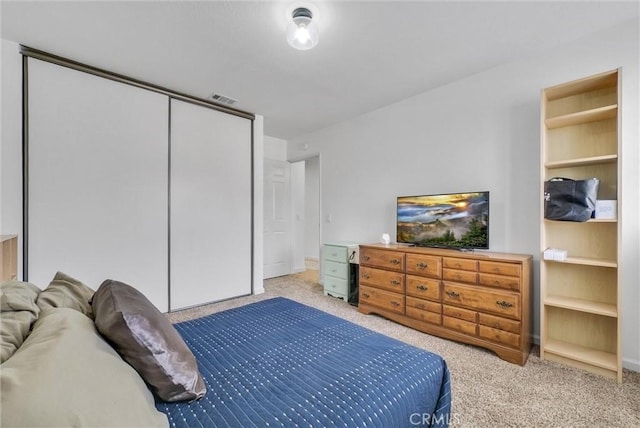 carpeted bedroom with a closet