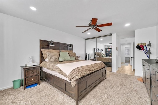 bedroom featuring light carpet, a closet, and ceiling fan