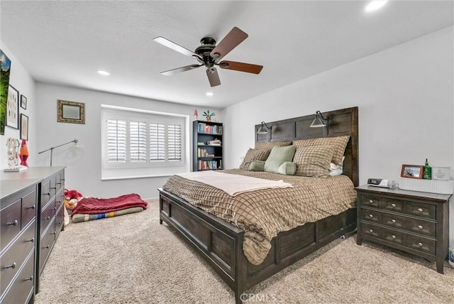 bedroom with ceiling fan and light colored carpet