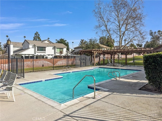 view of swimming pool with a patio and a pergola