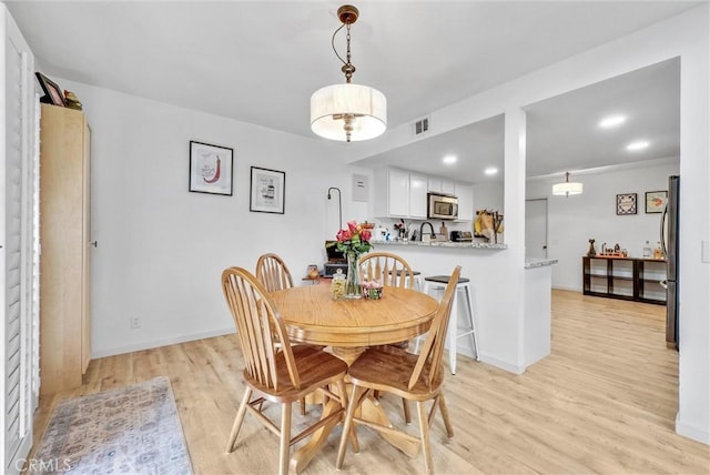 dining area with light hardwood / wood-style floors