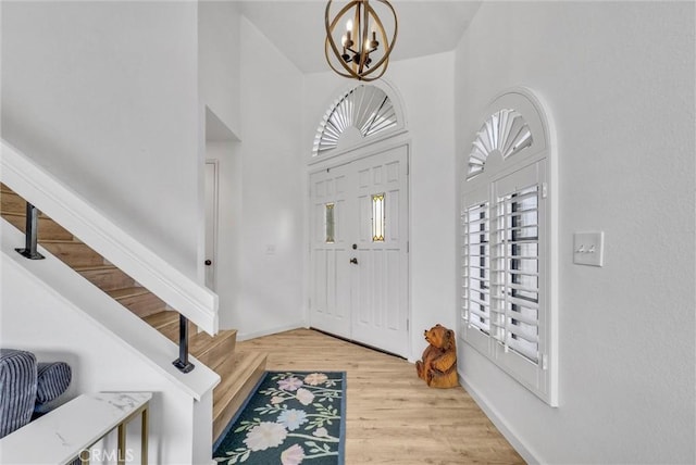 foyer with an inviting chandelier and light wood-type flooring