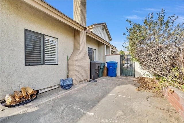 view of property exterior with a patio area