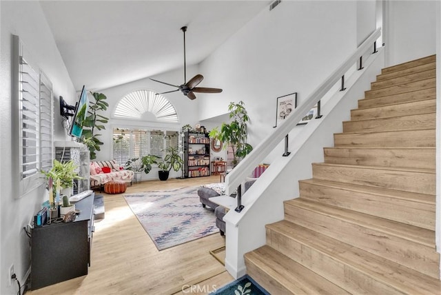 interior space with wood-type flooring, high vaulted ceiling, and ceiling fan