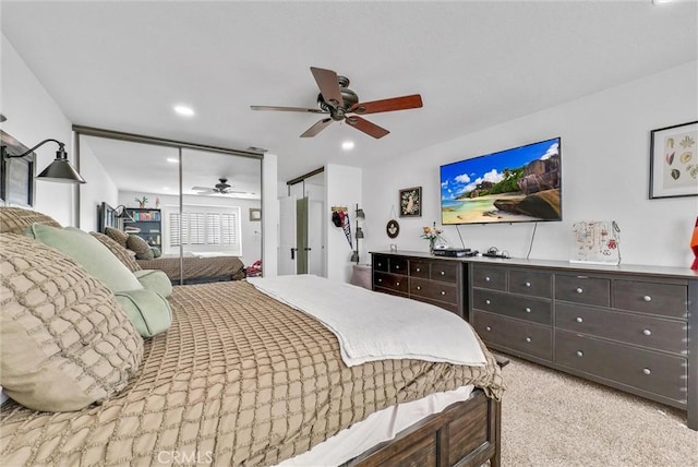 bedroom with light carpet and ceiling fan