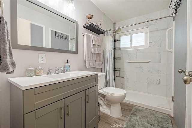 bathroom with hardwood / wood-style flooring, vanity, toilet, and a shower with shower curtain