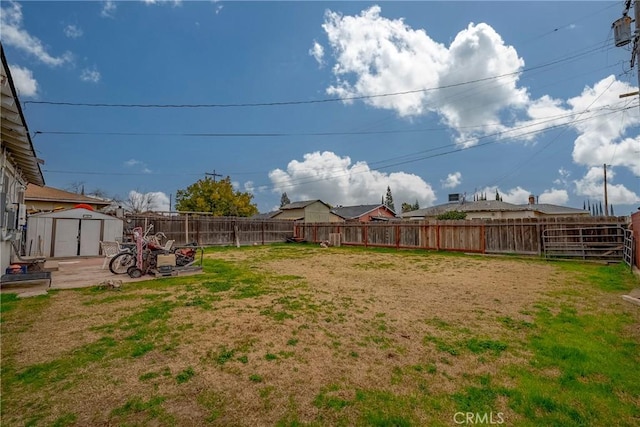 view of yard with a storage unit and a patio