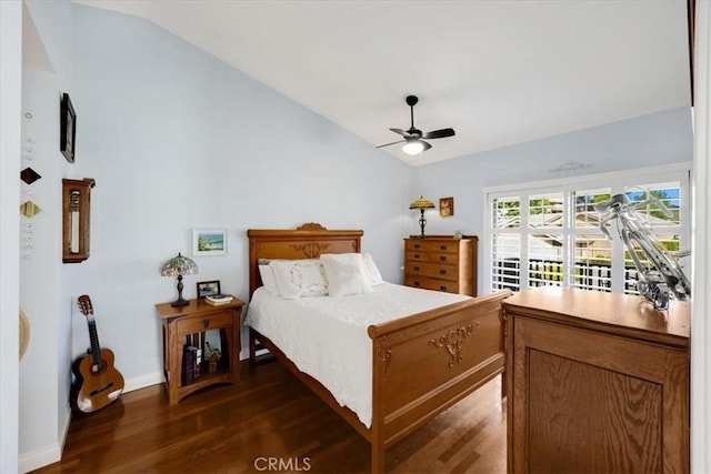 bedroom featuring lofted ceiling, ceiling fan, dark wood-style flooring, and baseboards