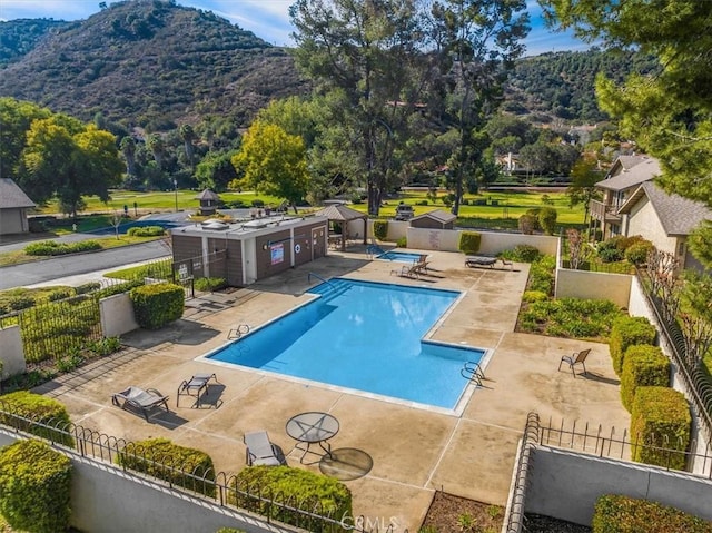 view of pool featuring a mountain view and a patio area