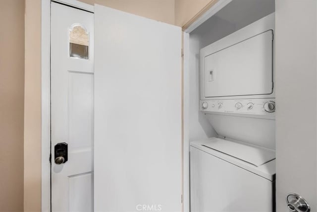 washroom with stacked washer and dryer