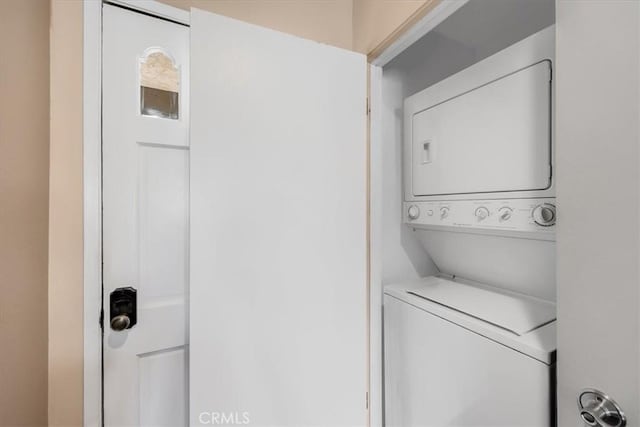 laundry room with laundry area and stacked washer / drying machine