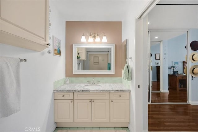 bathroom with hardwood / wood-style flooring and vanity