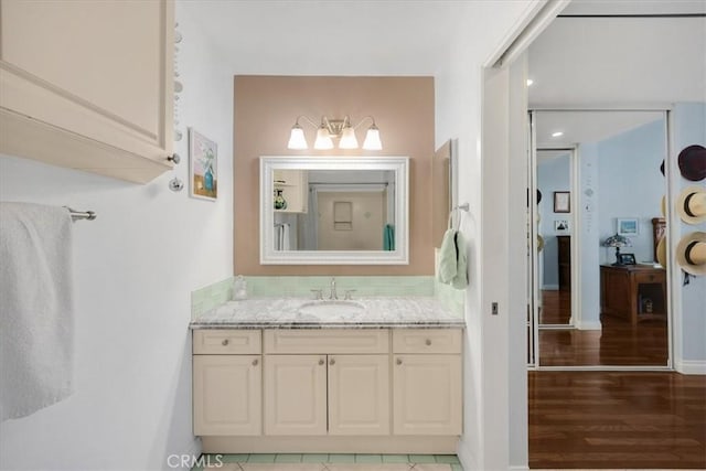 bathroom with vanity and wood finished floors