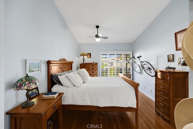 bedroom featuring vaulted ceiling, dark wood-type flooring, and ceiling fan