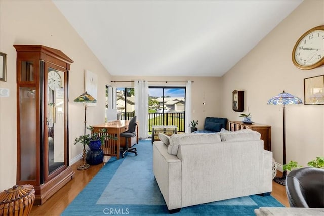 living room with hardwood / wood-style floors and high vaulted ceiling