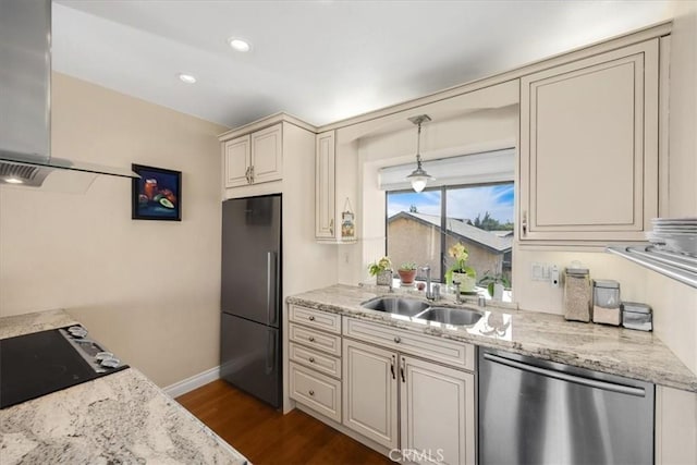 kitchen with pendant lighting, dishwasher, sink, black fridge, and light stone countertops