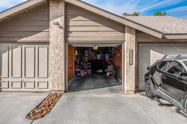 garage with concrete driveway