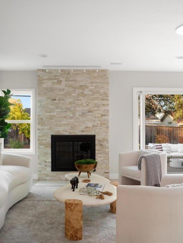 living room featuring a stone fireplace