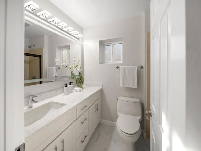 bathroom featuring vanity, walk in shower, and toilet