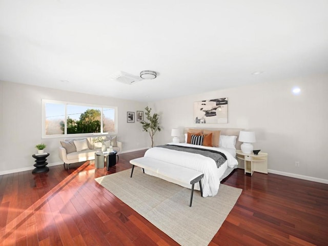 bedroom with dark hardwood / wood-style flooring