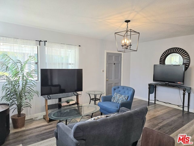 living room with hardwood / wood-style flooring and an inviting chandelier