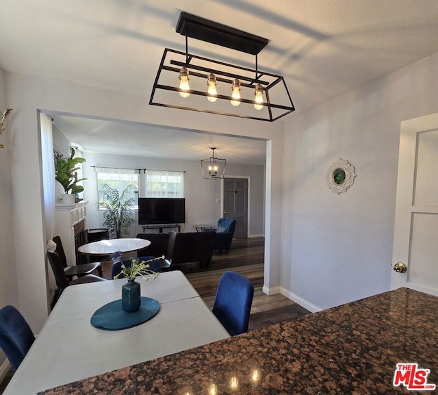 dining room with an inviting chandelier and dark hardwood / wood-style floors