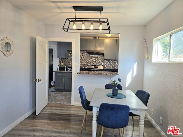 dining space with dark hardwood / wood-style floors