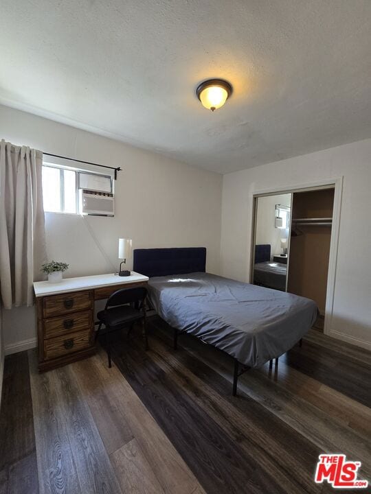 bedroom featuring dark hardwood / wood-style flooring and a closet